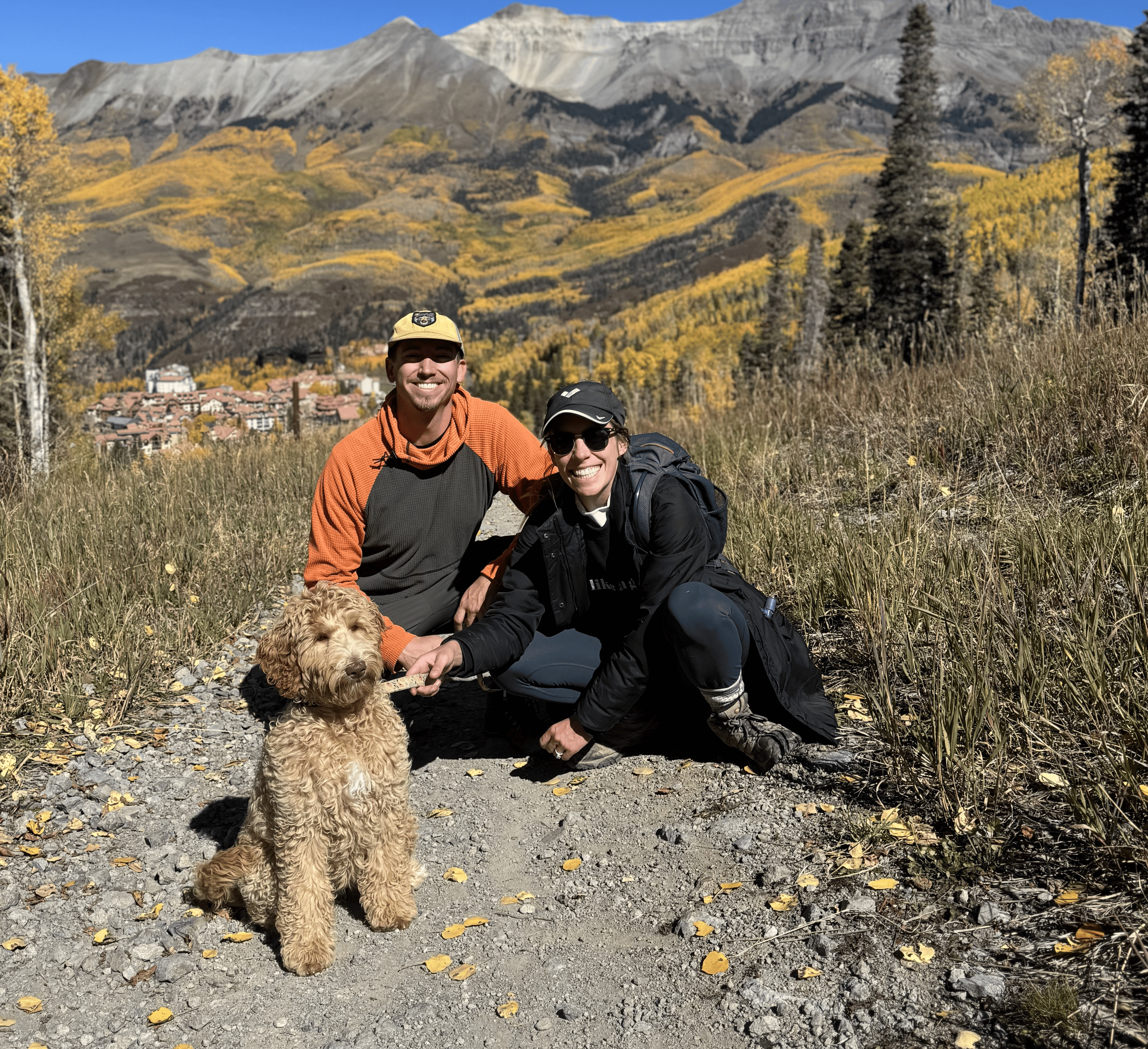 Tori and CJ with their dog in the mountains